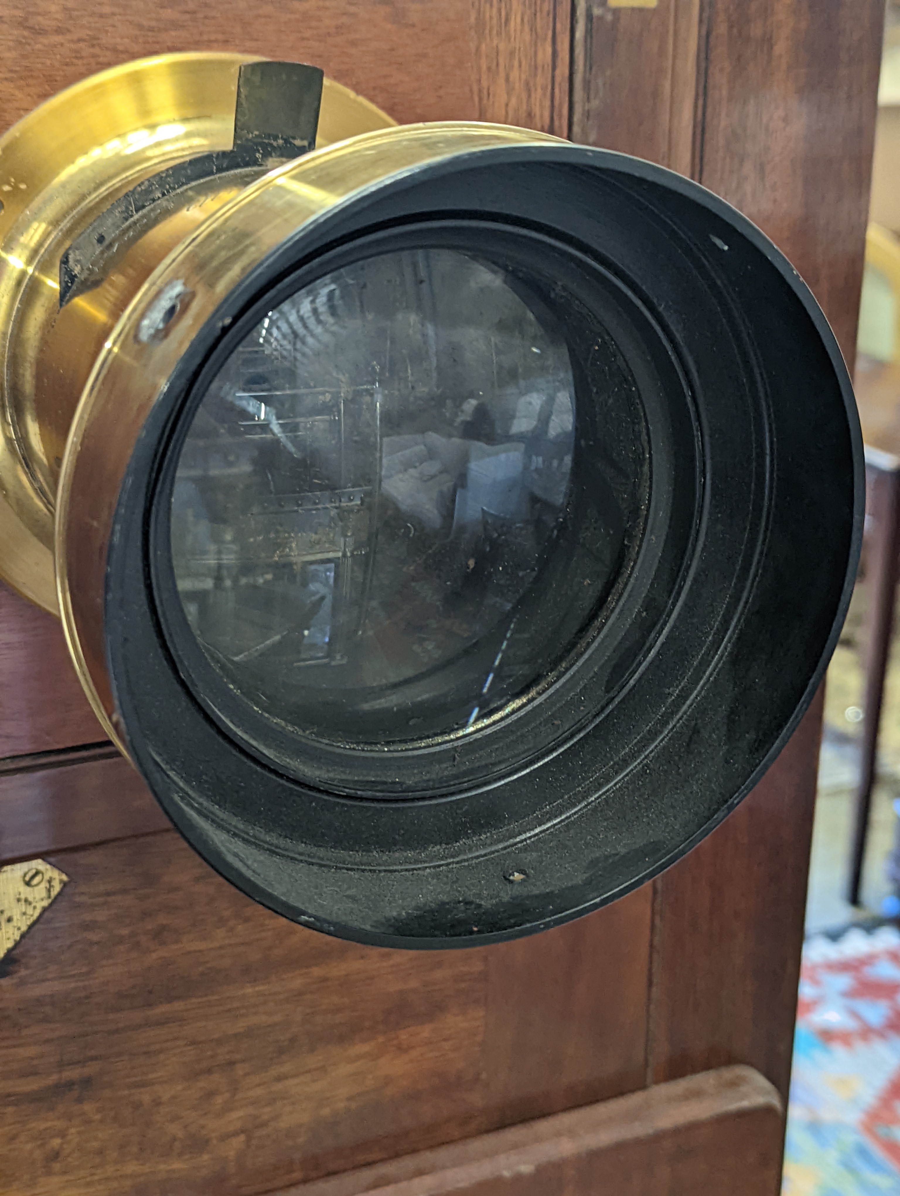 An early 20th century Hunter-Penrose Ltd. brass mounted mahogany studio plate camera, with 4in. lens, height 78cm, width 49cm